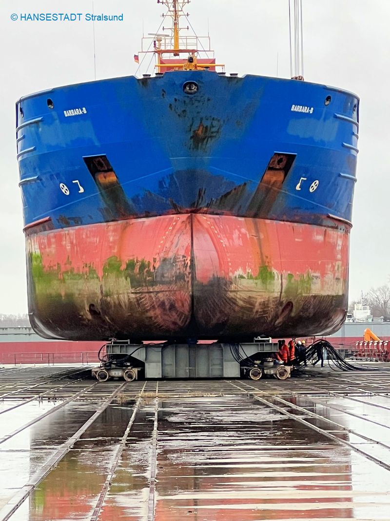 Das Schiff liegt auf dem Trockenen, darunter die Stapelwagen, auf denen das Schiff an seinen Reparaturplatz gerollt wird Das Schiff liegt auf dem Trockenen, darunter die Stapelwagen, auf denen das Schiff an seinen Reparaturplatz gerollt wird